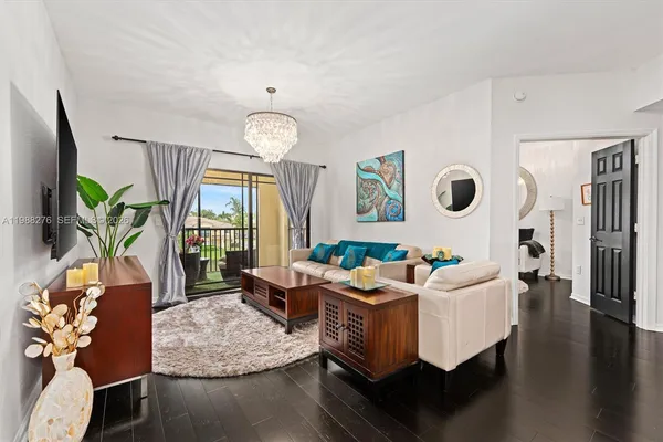 a living room with furniture wooden floor and a large window