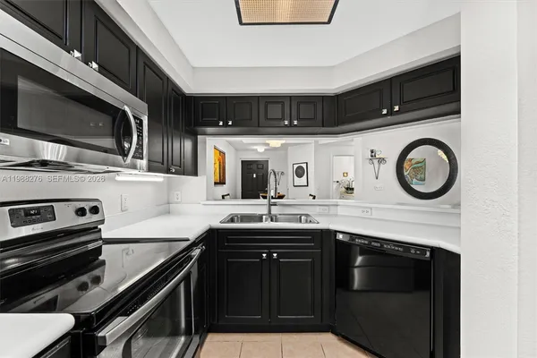 a kitchen with stainless steel appliances granite countertop a stove and a microwave