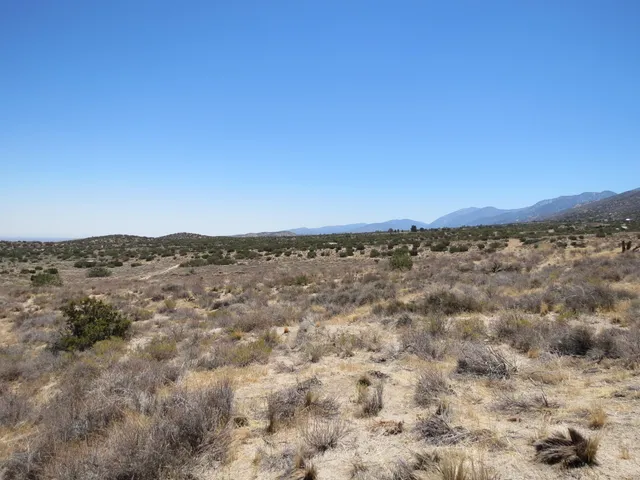 a view of a large mountain with mountains in the background