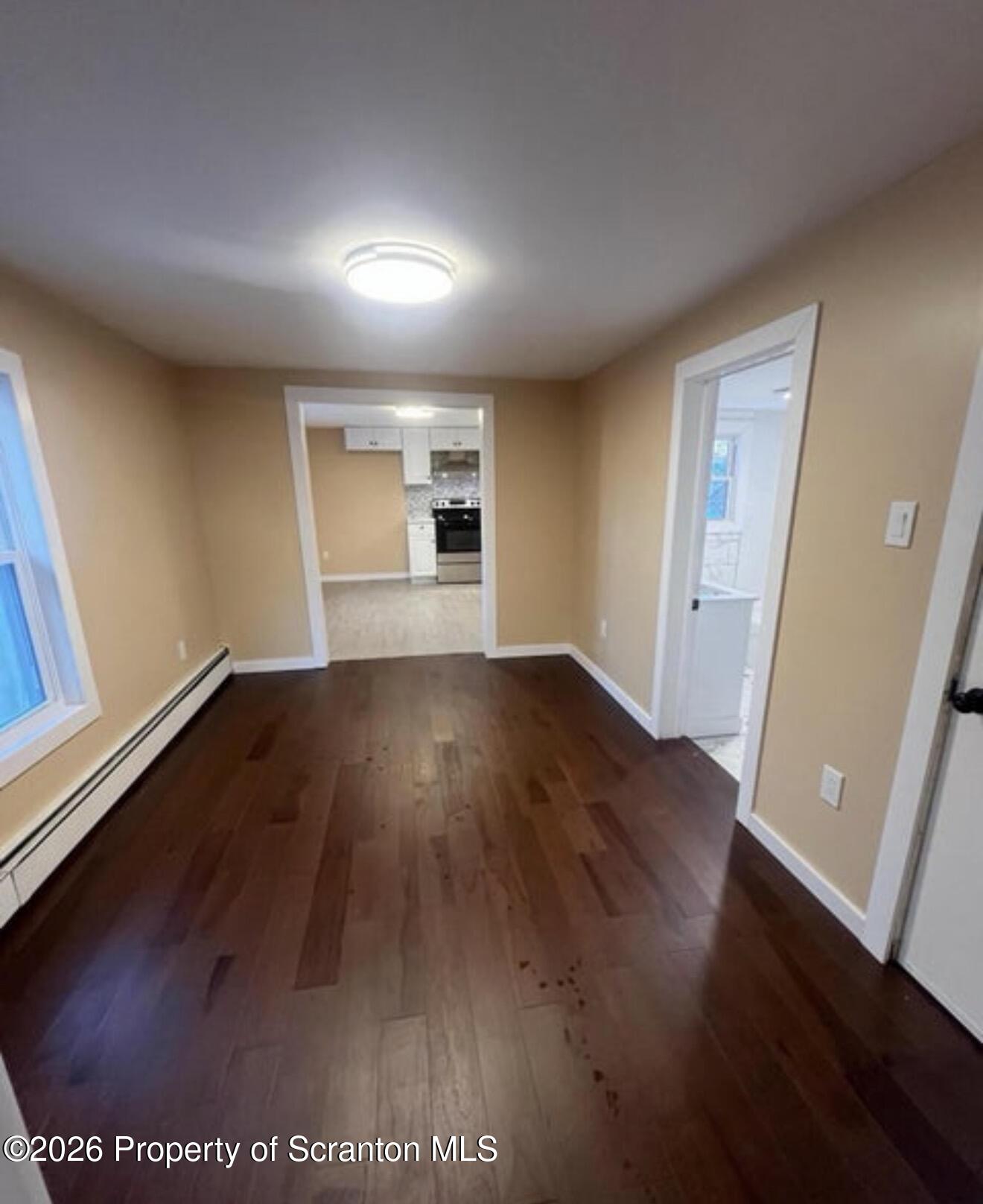 129 South Blakely Street, Unit 2 Dunmore, PA 18512 - Photo 4 of 8 an empty room with wooden floor and windows