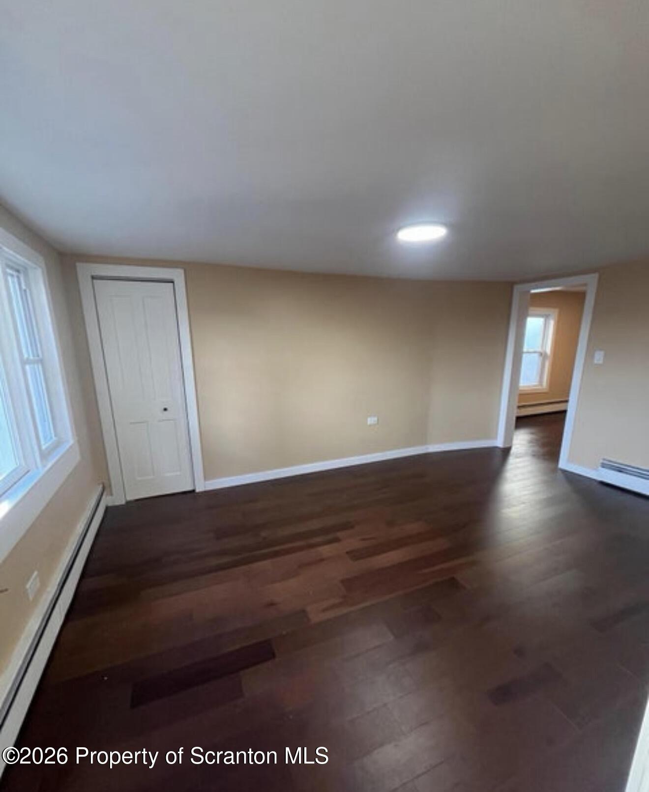 129 South Blakely Street, Unit 2 Dunmore, PA 18512 - Photo 5 of 8 an empty room with wooden floor and windows