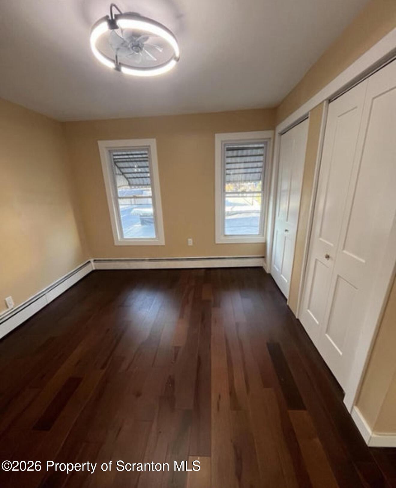 129 South Blakely Street, Unit 2 Dunmore, PA 18512 - Photo 7 of 8 an empty room with wooden floor and windows