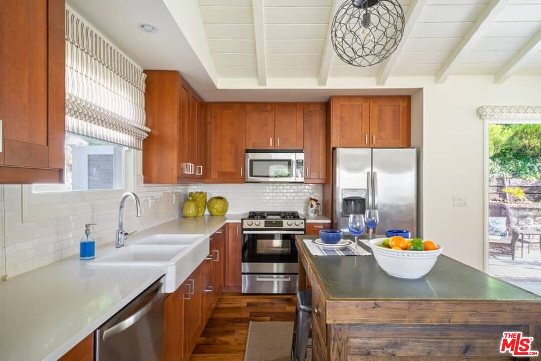 2850 Nichols Canyon Road Los Angeles, CA 90046 - Photo 11 of 38 a kitchen with stainless steel appliances kitchen island granite countertop a sink and a stove