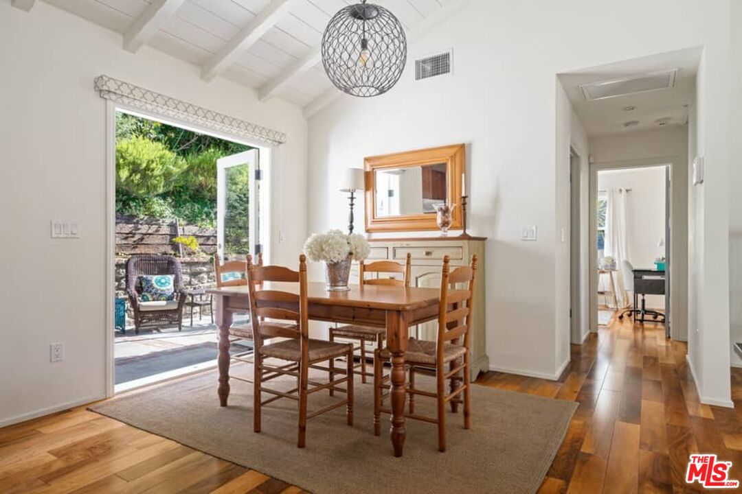 2850 Nichols Canyon Road Los Angeles, CA 90046 - Photo 14 of 38 a view of a dining room with furniture window and wooden floor