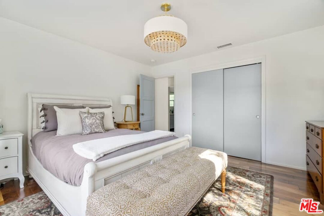 2850 Nichols Canyon Road Los Angeles, CA 90046 - Photo 17 of 38 a bedroom with a bed and a chandelier
