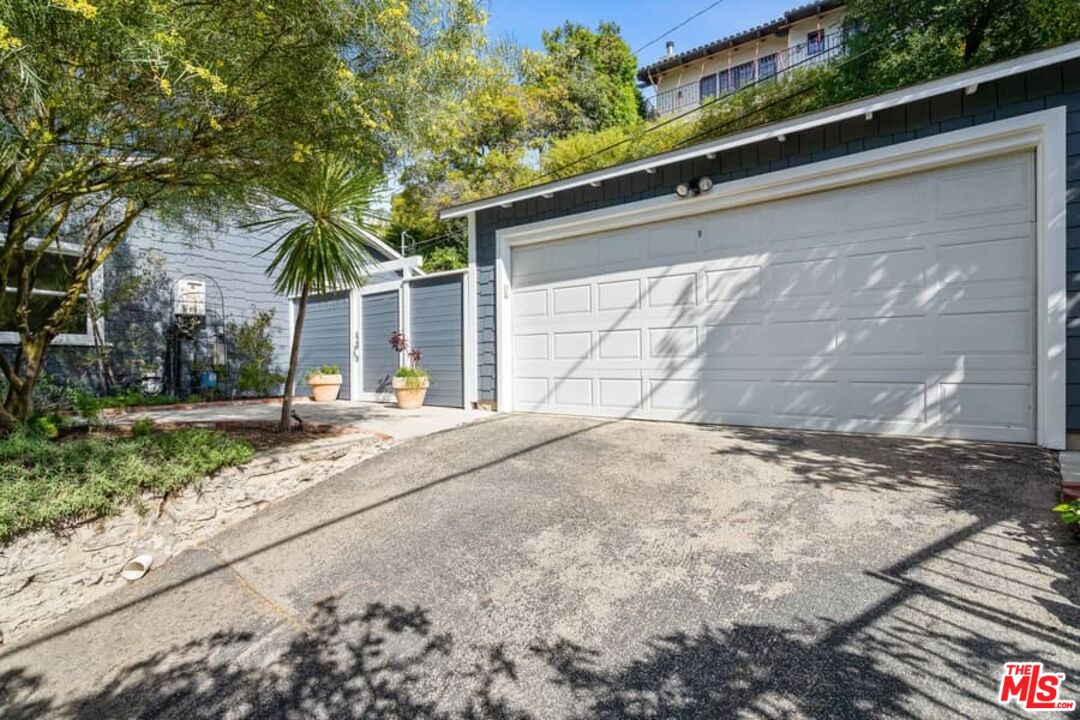 2850 Nichols Canyon Road Los Angeles, CA 90046 - Photo 28 of 38 a front view of a house with a yard and garage