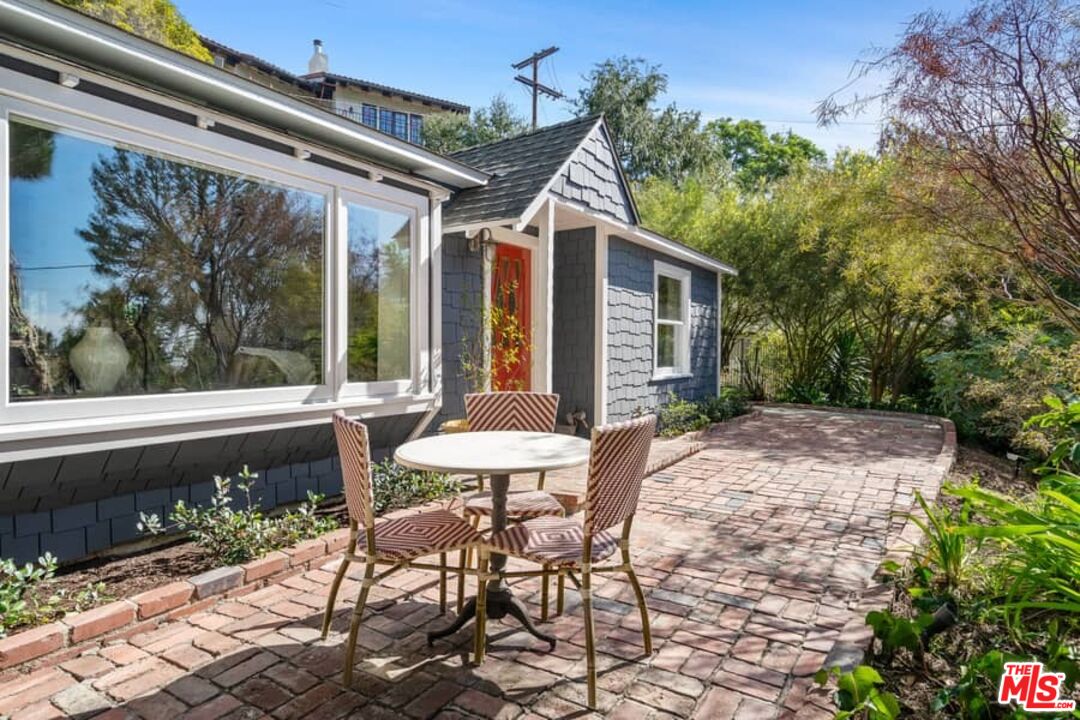 2850 Nichols Canyon Road Los Angeles, CA 90046 - Photo 5 of 38 a view of a patio with table and chairs with wooden floor and fence