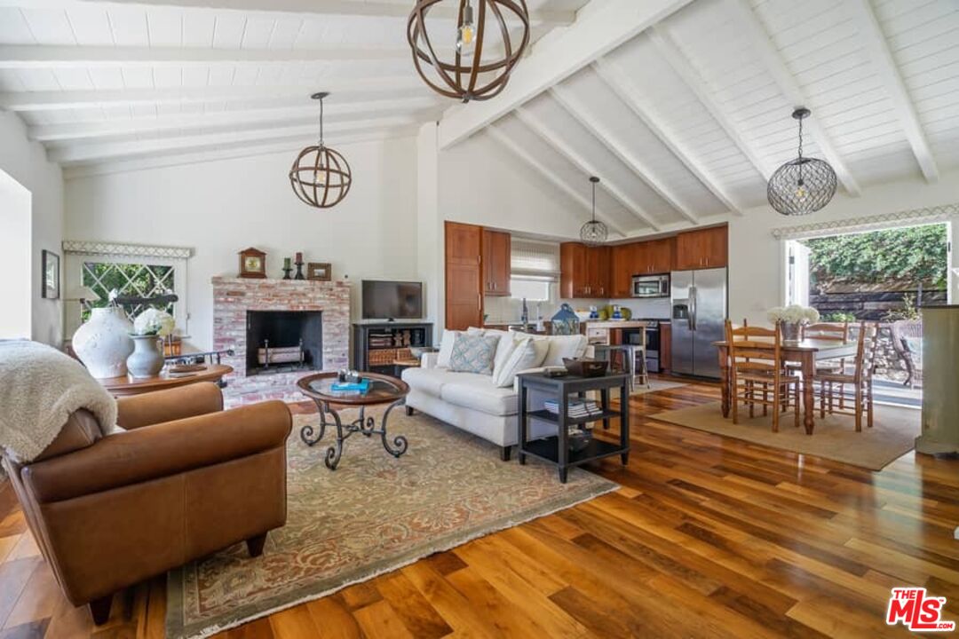 2850 Nichols Canyon Road Los Angeles, CA 90046 - Photo 6 of 38 a living room with furniture kitchen area and a fireplace