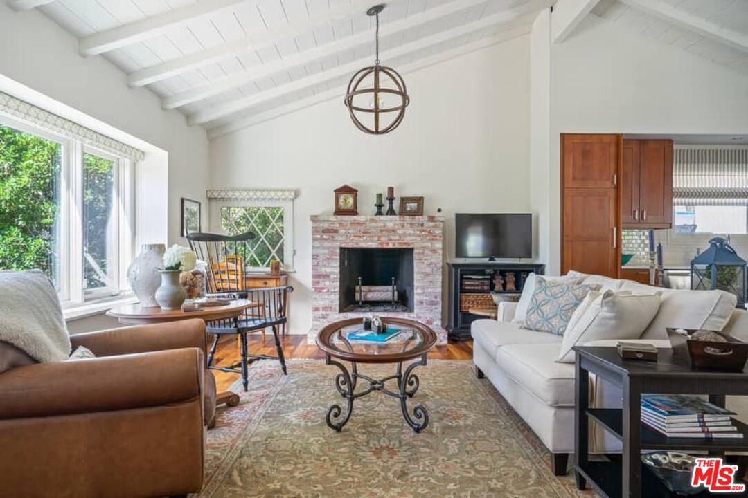 2850 Nichols Canyon Road Los Angeles, CA 90046 - Photo 7 of 38 a living room with furniture a fireplace and a large window