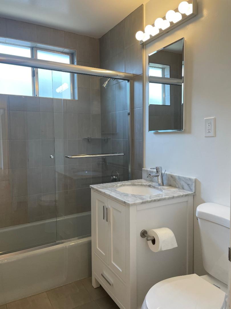 1320 Ridgewood Drive Millbrae, CA 94030 - Photo 14 of 18 a bathroom with a granite countertop sink a mirror and a toilet