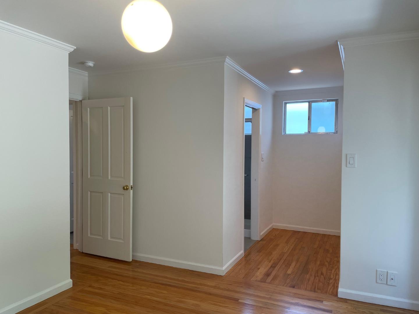 1320 Ridgewood Drive Millbrae, CA 94030 - Photo 16 of 18 an empty room with wooden floor and windows