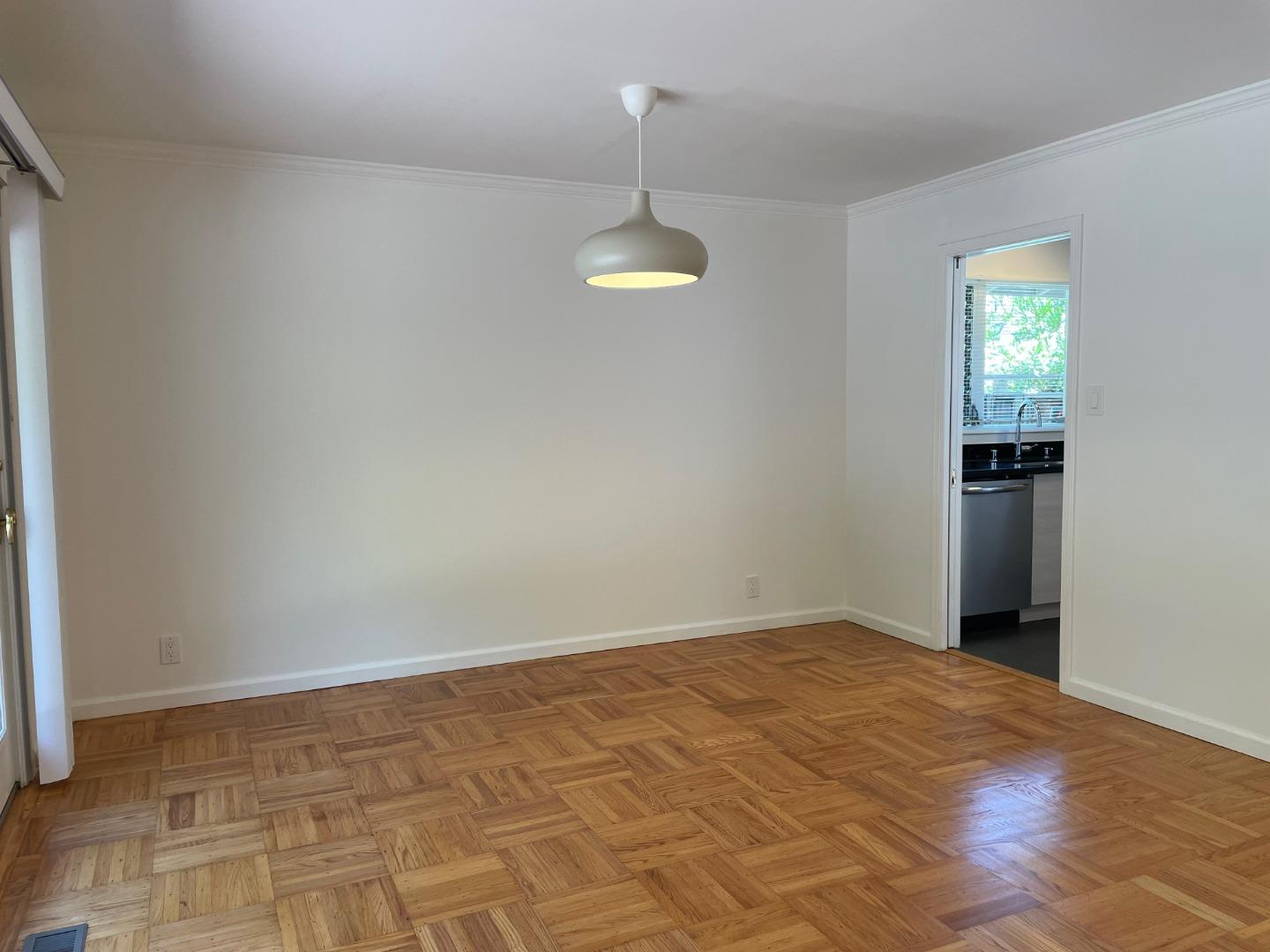 1320 Ridgewood Drive Millbrae, CA 94030 - Photo 3 of 18 a view of an empty room with wooden floor and a window