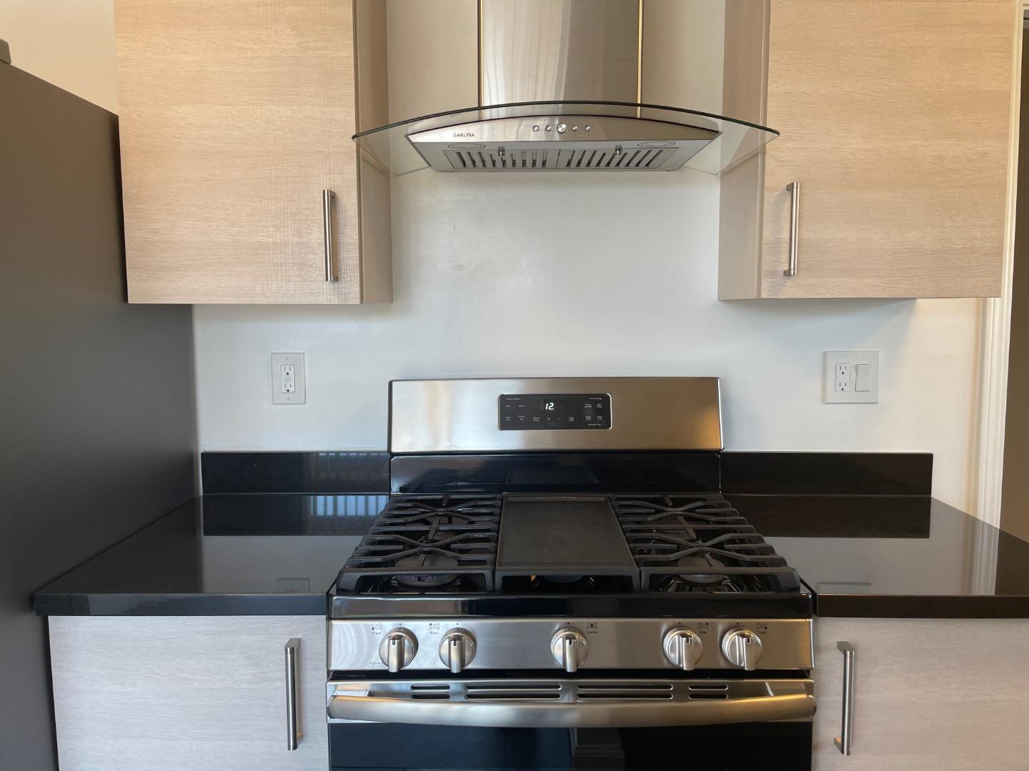 1320 Ridgewood Drive Millbrae, CA 94030 - Photo 6 of 18 a stove top oven sitting inside of a kitchen