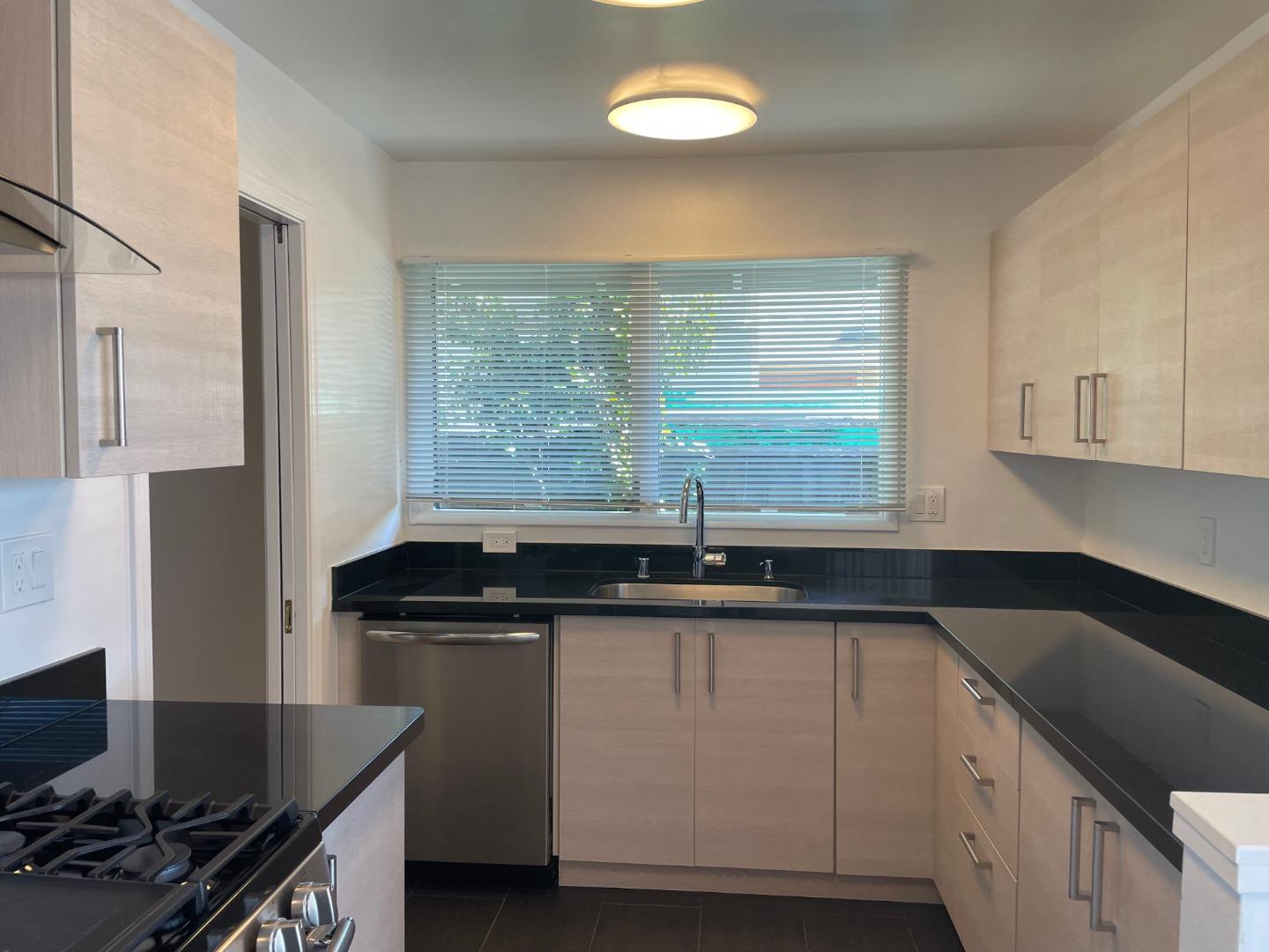 1320 Ridgewood Drive Millbrae, CA 94030 - Photo 7 of 18 a kitchen with granite countertop a sink and a stove