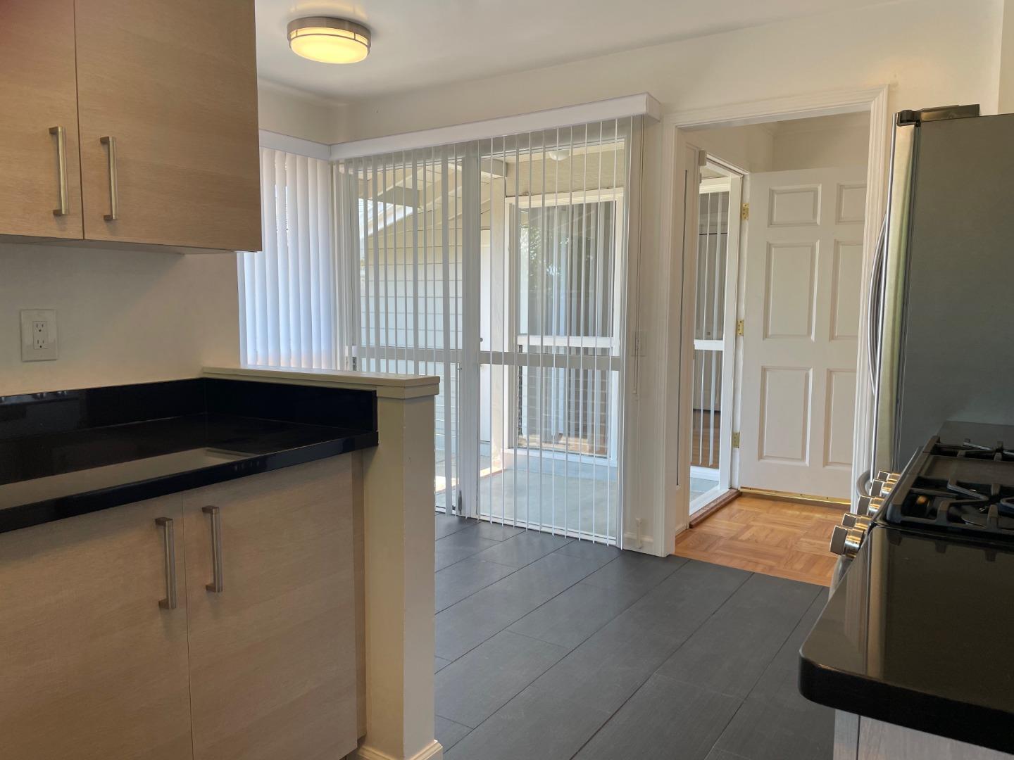1320 Ridgewood Drive Millbrae, CA 94030 - Photo 8 of 18 a kitchen with a refrigerator and a sink