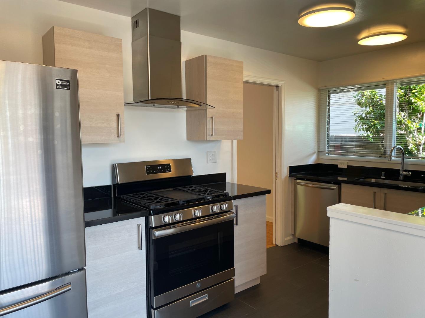1320 Ridgewood Drive Millbrae, CA 94030 - Photo 10 of 18 a kitchen with stainless steel appliances a stove and a refrigerator