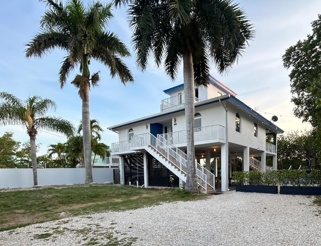 a view of a house with a swimming pool and a patio
