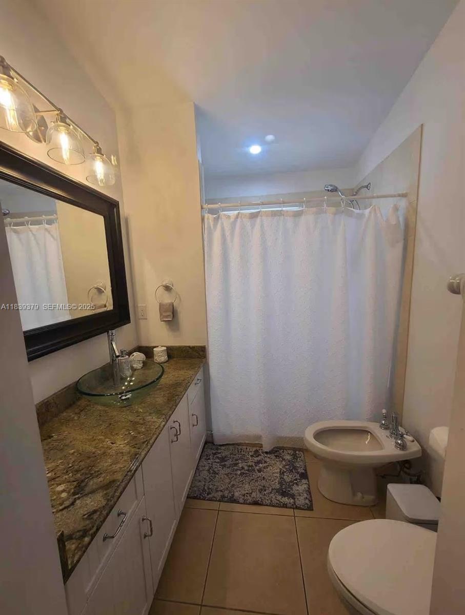 350 Hazel Street, Unit 350 Key Largo, FL 33037 - Photo 9 of 11 a bathroom with a granite countertop sink toilet and mirror