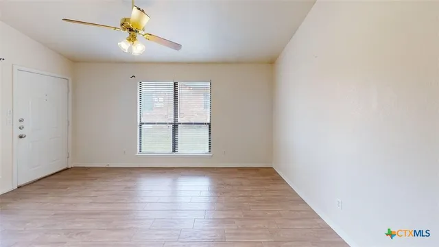 wooden floor in an empty room with a window