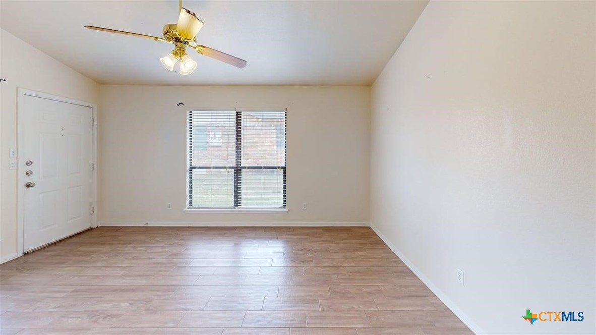 802 Hackberry Street, Unit A Copperas Cove, TX 76522 - Photo 11 of 11 wooden floor in an empty room with a window