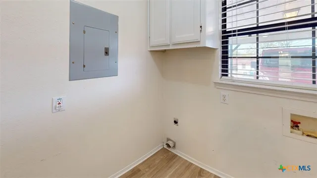 a view of storage and utility room with window