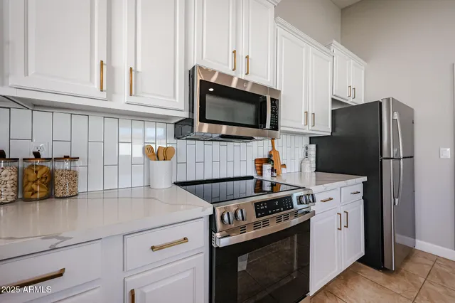 a kitchen with stainless steel appliances a stove microwave and refrigerator