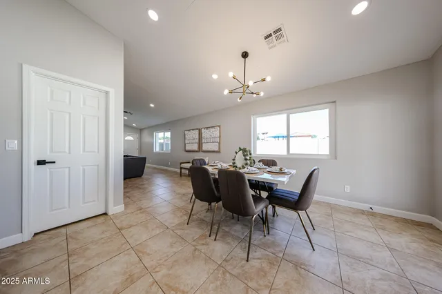 a view of a dining room with furniture and chandelier