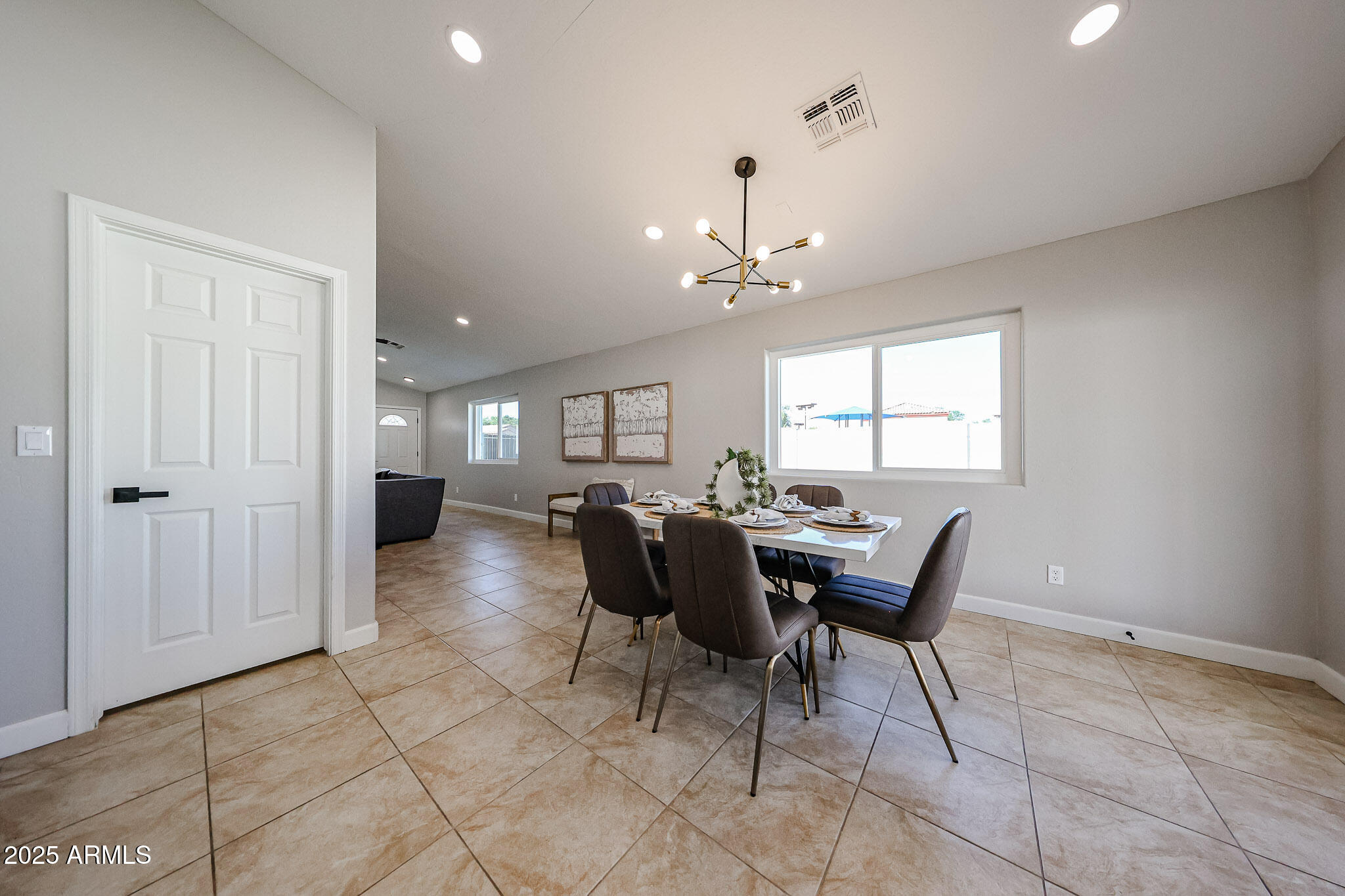 10334 East Diamond Avenue Mesa, AZ 85208 - Photo 14 of 39 a view of a dining room with furniture and chandelier