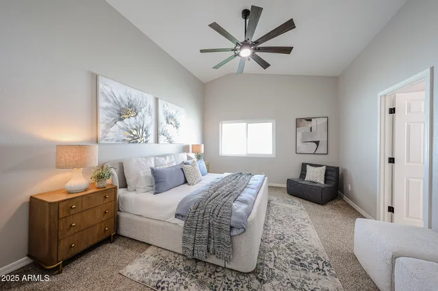 a bedroom with a bed a couch and a window