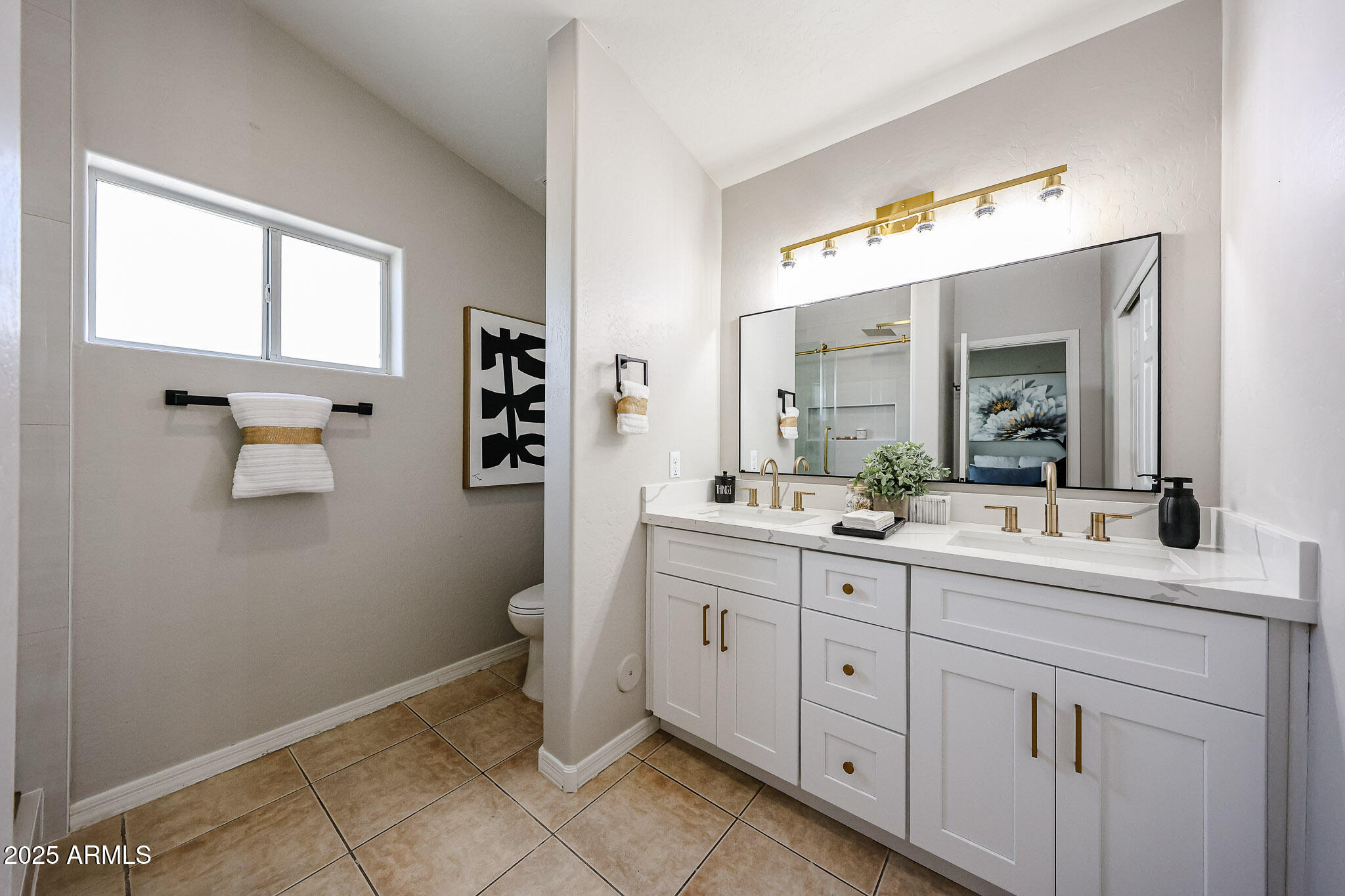 10334 East Diamond Avenue Mesa, AZ 85208 - Photo 17 of 39 a spacious bathroom with a double vanity sink a mirror and a toilet