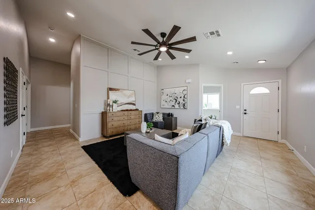 a room with furniture a ceiling fan and a rug