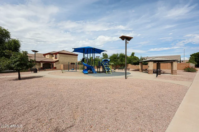 a park view with a bench under an umbrella