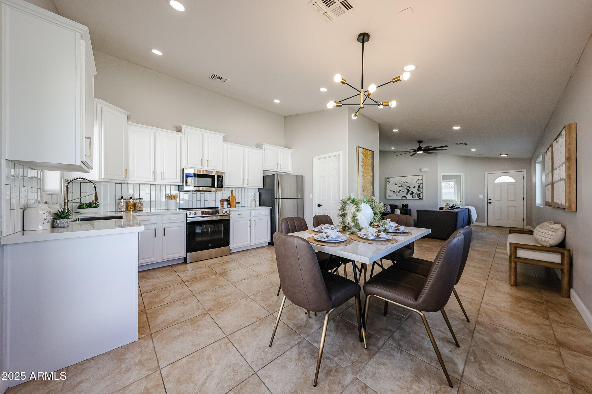 10334 East Diamond Avenue Mesa, AZ 85208 - Photo 7 of 39 a kitchen with a dining table chairs stainless steel appliances and cabinets