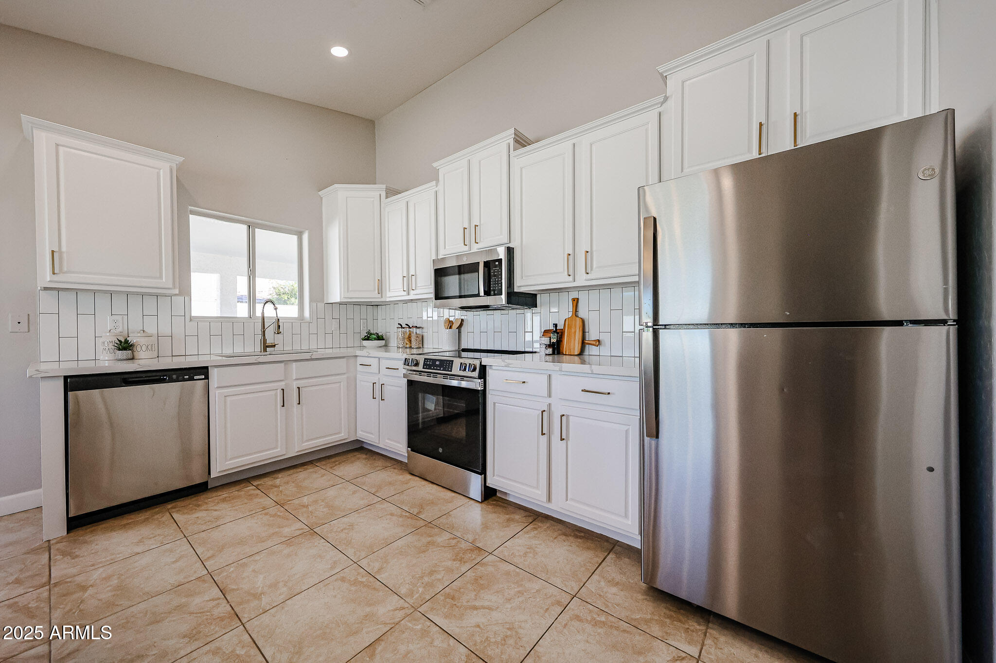 10334 East Diamond Avenue Mesa, AZ 85208 - Photo 8 of 39 a kitchen with cabinets stainless steel appliances and window