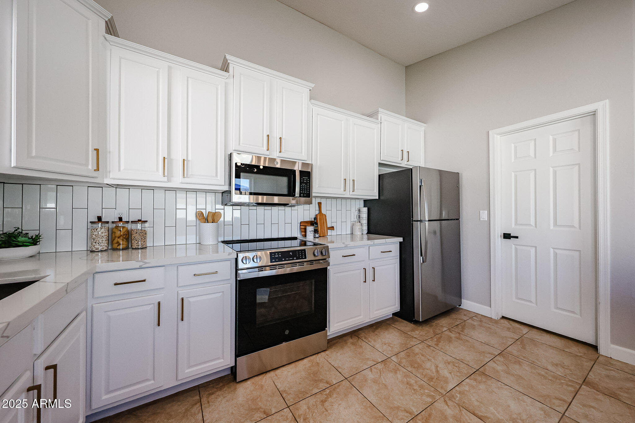 10334 East Diamond Avenue Mesa, AZ 85208 - Photo 9 of 39 a kitchen with white cabinets and stainless steel appliances
