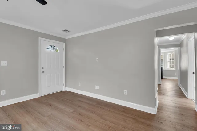 a view of a room with wooden floor