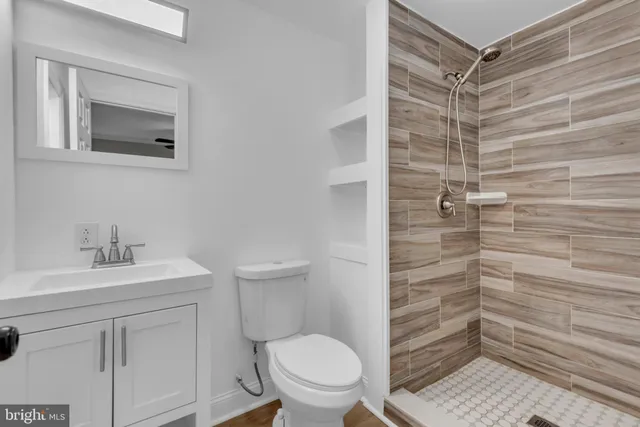 a bathroom with a toilet a sink and a shower