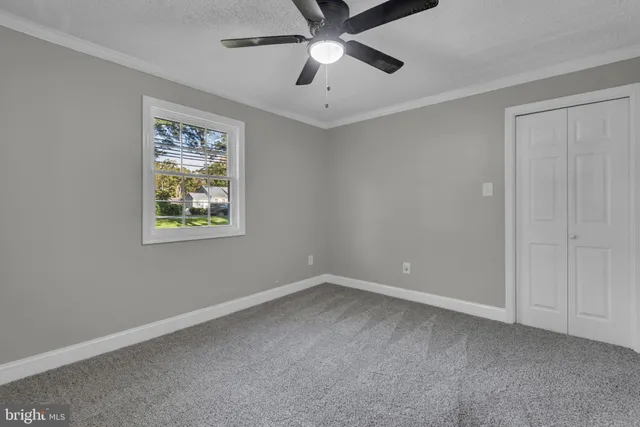 a view of room with window and ceiling fan