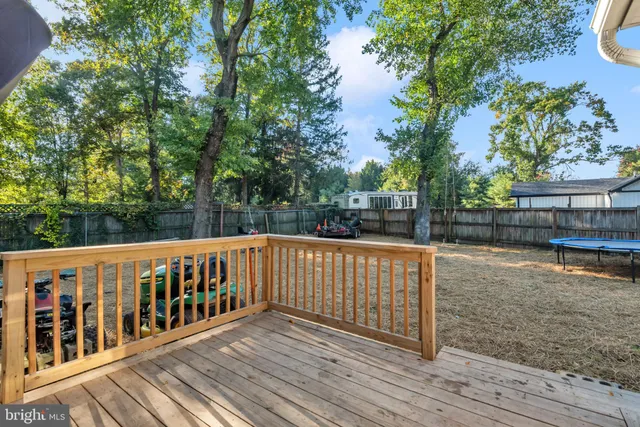 a balcony with wooden floor and fence