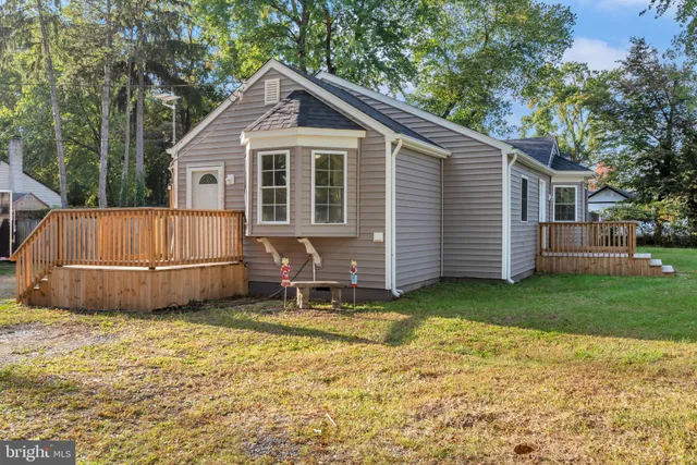 a view of a house with a yard and seating area