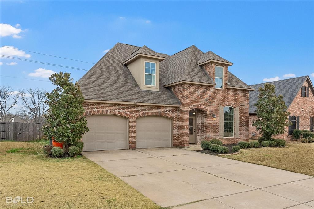 946 Maize Street Bossier City, LA 71111 - Photo 5 of 39 a front view of a house with a garden and garage