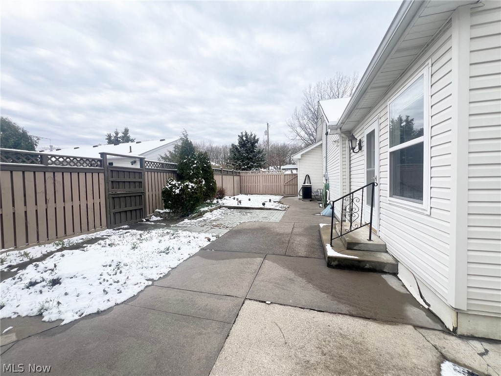 5203 Ridgeland Street Lorain, OH 44055 - Photo 29 of 39 View of snow covered exterior with a patio