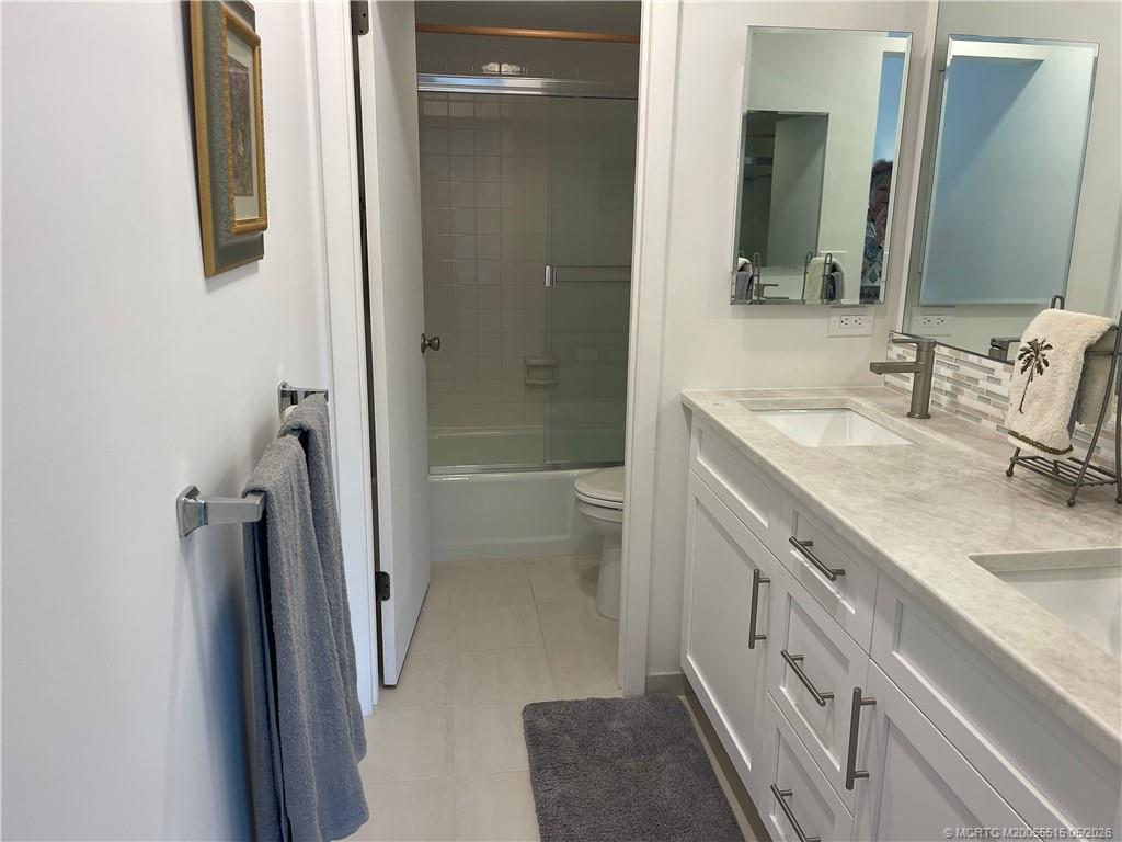 1858 Southwest Palm City Road, Unit 203 Stuart, FL 34994 - Photo 15 of 21 a bathroom with a sink a toilet and shower
