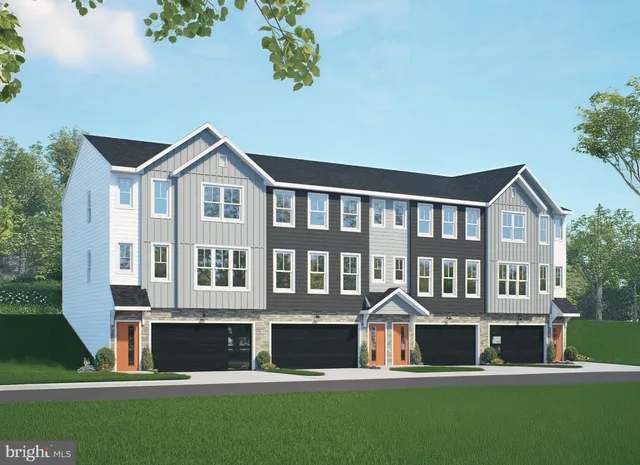 a front view of residential houses with yard