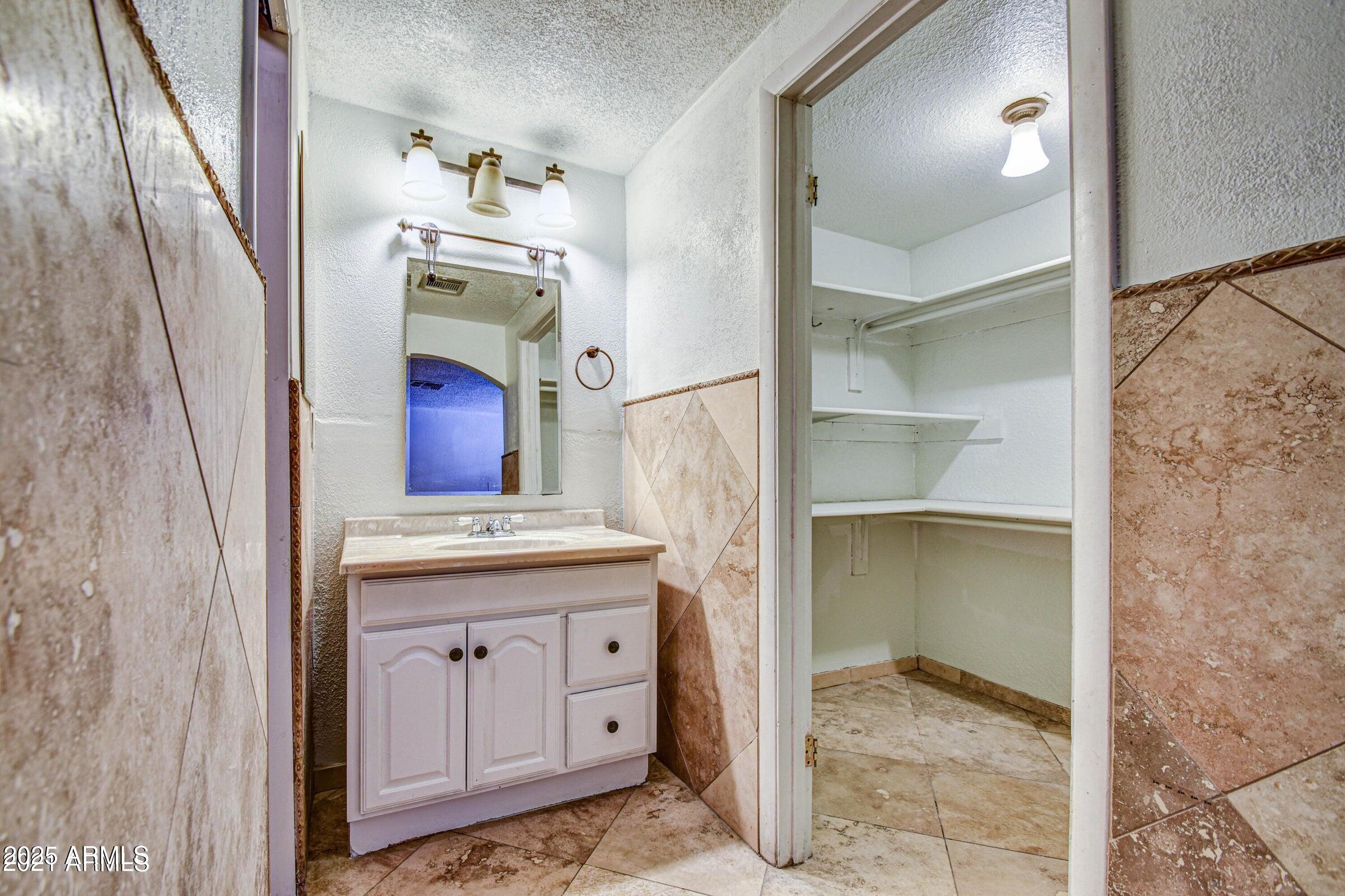 17629 North 36th Street Phoenix, AZ 85032 - Photo 11 of 20 a room with cabinets and wooden floor
