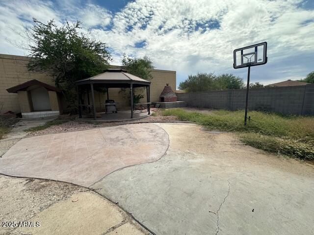17629 North 36th Street Phoenix, AZ 85032 - Photo 18 of 20 a backyard of a house with table and chairs under an umbrella