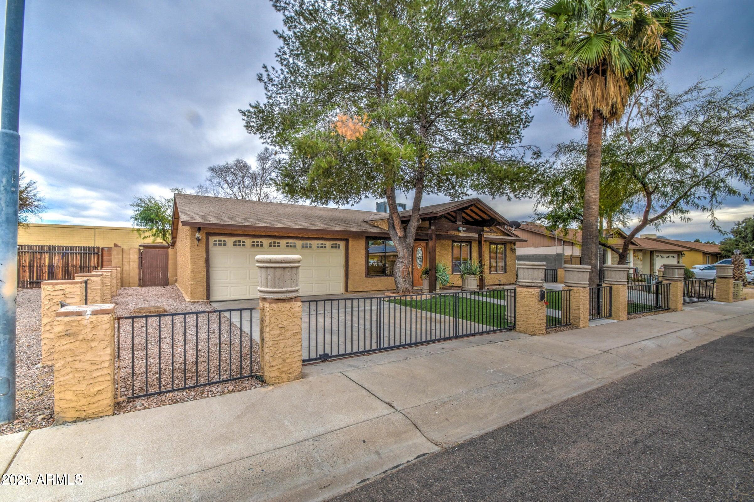 17629 North 36th Street Phoenix, AZ 85032 - Photo 20 of 20 a view of a house with a wooden fence