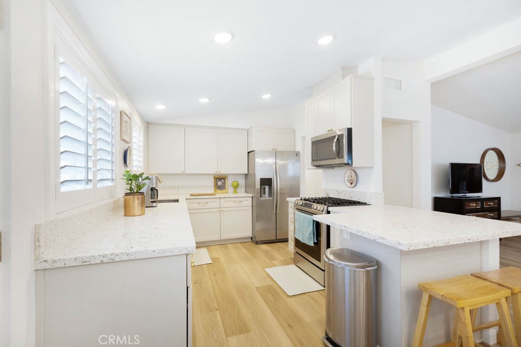954 Delay Avenue Glendora, CA 91740 - Photo 13 of 35 a kitchen with a sink a stove top oven a stove and a refrigerator