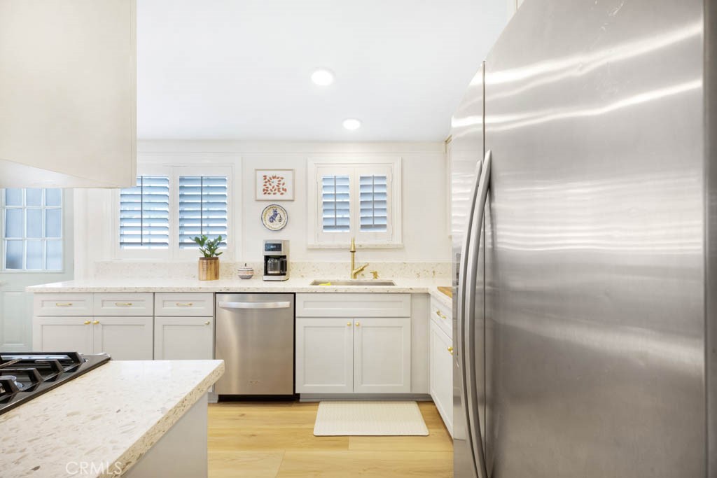 954 Delay Avenue Glendora, CA 91740 - Photo 18 of 35 a kitchen with white cabinets and white appliances