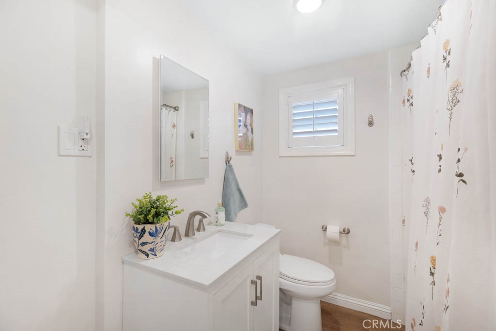 954 Delay Avenue Glendora, CA 91740 - Photo 23 of 35 a bathroom with a sink toilet and a mirror
